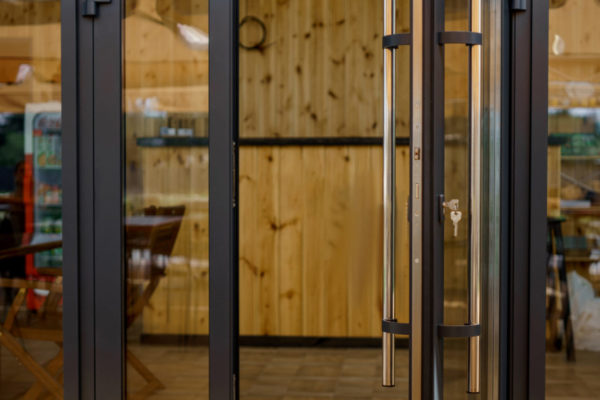 Elegant wooden home terrace with balcony. doors from bathroom and bedroom. Panorama of spacious terrace with wooden floor and furniture and amazing view.